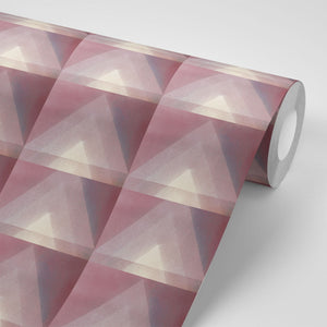 Motif wallpaper by Tatie Lou in pink, sample roll showing geometric pyramids
