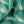 Motif velvet by Tatie Lou in green, draped, showing geometric pyramids
