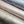 Moucheté wallpaper by House of Amitié in pink, partly unrolled roll showing soft marbled spots