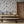 Newtown Creek wallpaper by XV Interiors in grey, drifting feathers in a dining room