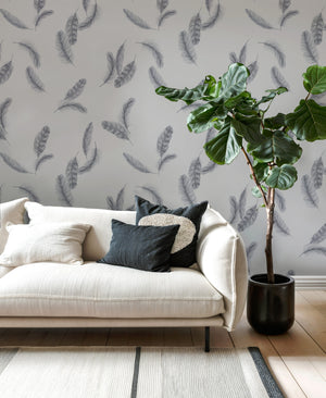 Newtown Creek wallpaper by XV Interiors in grey, drifting feathers behind a sofa in a living room