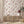 Newtown Creek wallpaper by XV Interiors in cream and rust, drifting feathers above a sideboard