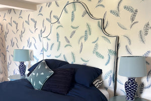 Newtown Creek wallpaper by XV Interiors in cream, drifting feathers in a living room