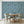 Newtown Creek wallpaper by XV Interiors in blue, drifting feathers behind a dining table