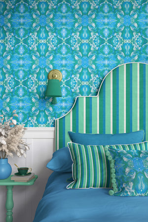Naples wallpaper by Liberty James Studio in blue, an ornate kaleidoscope design in a bedroom