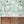 Octopus wallpaper by Brand McKenzie in mint green, octopus and sea life in a bathroom setting