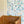 Olympia wallpaper by Claire de Quénetain in pink and red, a hand-painted floral design in a styled room setting