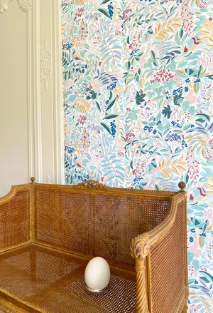 Olympia wallpaper by Claire de Quénetain in pink and red, a hand-painted floral design in a styled room setting