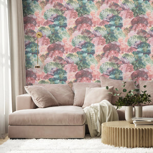 Painting in Colour wallpaper by Brand McKenzie in pastel, painterly floral clouds behind a sofa in a living room