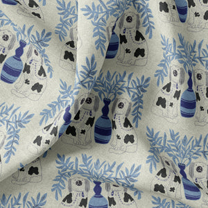 Pair of Dogs linen by Annika Reed in blue, draped close-up of pairs of dogs and vases