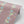 Passion Flower wallpaper by Tatie Lou in dusky pink, partly unrolled roll showing trailing passion flowers