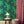 Peacock wallpaper by Dupenny in green, peacocks in branches in a styled room setting