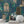 Peacock Manor wallpaper by Brand McKenzie in indigo blue, peacocks and arched windows behind a console table