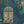 Peacock Manor wallpaper by Brand McKenzie in indigo blue, close-up of peacocks and arched windows