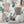 Peacock Manor wallpaper by Brand McKenzie in pink, peacocks and arched windows above a sideboard