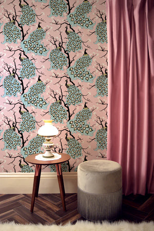 Peacock wallpaper by Dupenny in pink, peacocks in branches on a feature wall