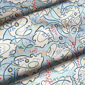 Penelope linen by Claire de Quénetain in green and blue, draped, showing a hand-painted floral design