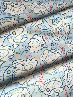 Penelope linen by Claire de Quénetain in green and blue, draped, showing a hand-painted floral design