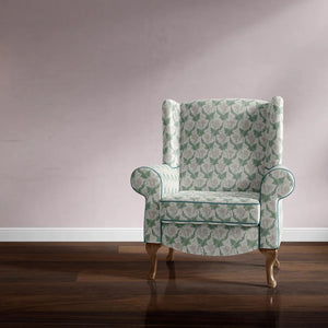 Bindweed Pink Trumpet velvet by Annika Reed in green and pink, trailing bindweed flowers upholstered on an armchair