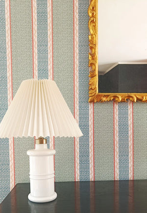 Pio wallpaper by Claire de Quénetain in brown, fine stripes above a sideboard