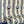 Popsicle wallpaper by Liberty James Studio in gold and navy, partly unrolled roll showing wavy popsicle stripes