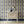 Popsicle wallpaper by Liberty James Studio in gold and navy, wavy popsicle stripes above a sideboard