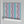 Popsicle wallpaper by Liberty James Studio in teal and pink, partly unrolled roll showing wavy popsicle stripes