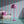 Popsicle wallpaper by Liberty James Studio in teal and pink, wavy popsicle stripes in a bathroom