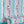 Popsicle wallpaper by Liberty James Studio in teal and pink, wavy popsicle stripes in a living room