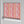 Popsicle wallpaper by Liberty James Studio in pink and coral, wavy popsicle stripes on a bedroom wall