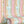 Popsicle wallpaper by Liberty James Studio in pink and blue, partly unrolled roll showing wavy popsicle stripes