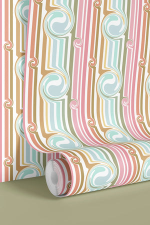 Popsicle wallpaper by Liberty James Studio in pink and blue, partly unrolled roll showing wavy popsicle stripes