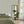 Popsicle wallpaper by Liberty James Studio in sage green, wavy popsicle stripes in a bedroom