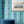 Popsicle wallpaper by Liberty James Studio in teal, wavy popsicle stripes on a bathroom wall