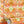 Psychedelic Pop Wallpaper wallpaper by Liberty James Studio in orange, sample roll showing a psychedelic mirrored design