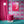 Psychedelic Pop Wallpaper wallpaper by Liberty James Studio in pink behind a sofa in a living room