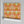 Psychedelic Pop Wallpaper wallpaper by Liberty James Studio in orange, partly unrolled roll showing