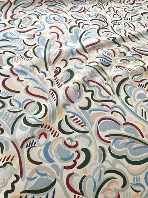 Raphaelle linen by Claire de Quénetain in blue, draped close-up of a hand-painted floral design