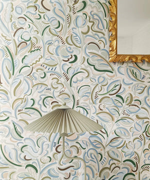 Raphaelle wallpaper by Claire de Quénetain in green, a hand-painted floral design above a sideboard