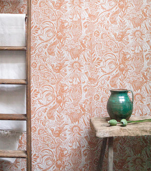 Squirrel and Sunflower wallpaper by St. Jude's in pink, squirrels and sunflowers above a sideboard