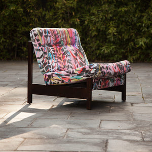 Rita Does Jazz velvet by The Monkey Puzzle Tree in pink and blue, an energetic painted design upholstered on an armchair