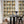 Roar Emotions wallpaper by Brand McKenzie in orange and cream, pop-art tiger faces behind a dining table