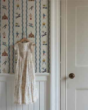 Run Away to the Circus wallpaper by Annika Reed in cream, circus performers and tents in a hallway