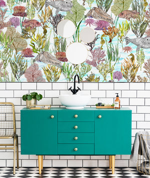 Seaview wallpaper by XV Interiors in blue, fish among seaweed above a sideboard