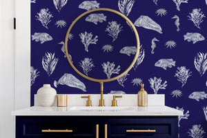 Solent Snapper wallpaper by XV Interiors in navy, fish, seahorses and coral in a bathroom