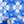 Santorini Tile wallpaper by Liberty James Studio in blue and white, partly unrolled roll showing