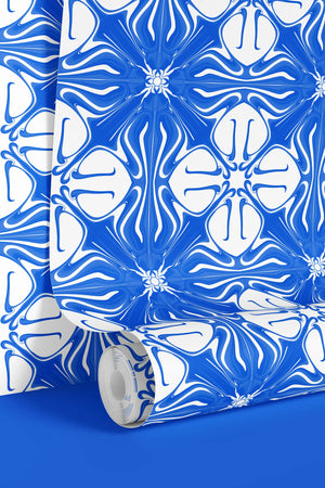 Santorini Tile wallpaper by Liberty James Studio in blue and white, partly unrolled roll showing