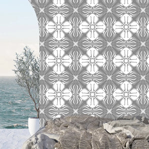 Santorini Tile wallpaper by Liberty James Studio in grey and white, a Mediterranean tile pattern on a bedroom wall