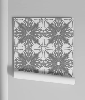 Santorini Tile wallpaper by Liberty James Studio in grey and white, partly unrolled roll showing