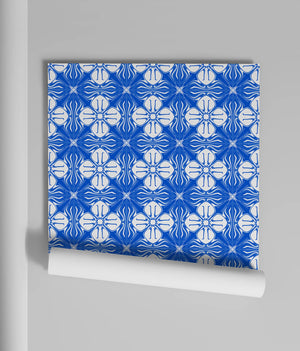 Santorini Tile wallpaper by Liberty James Studio in blue, partly unrolled roll showing (alternate view)